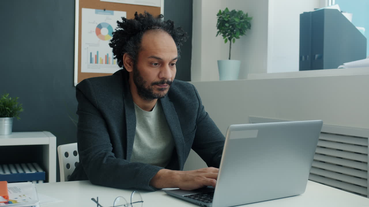 Businessman Working on Laptop in Office