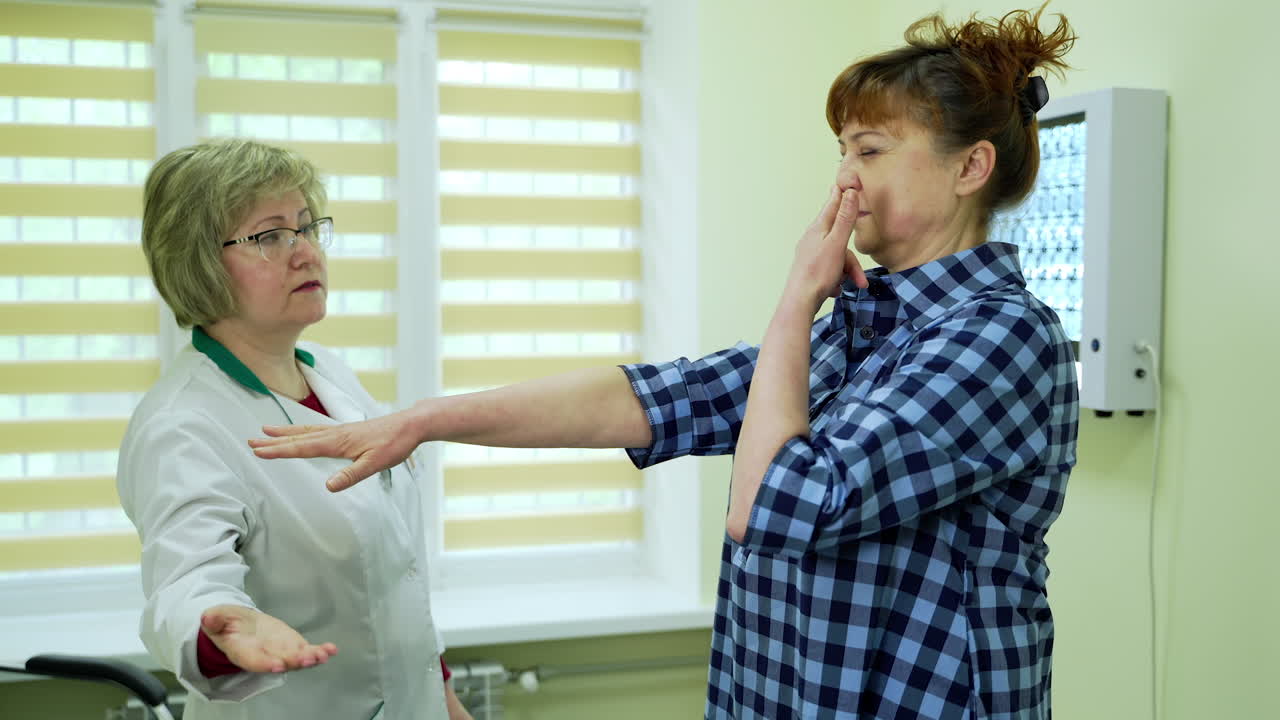 Physical examination of hands reflexes. Doctor neurologist examines a patient in a clinic
