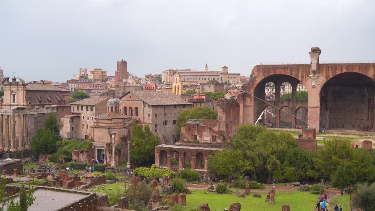 Picturesque cityscape aerial view of Rome, Italy, old ruins and archaeological UNESCO outdoor historic stone attraction, handheld pan right