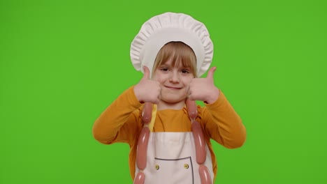 Child-girl-kid-dressed-as-cook-chef-showing-thumbs-up,-smiling,-looking-at-camera-on-chroma-key