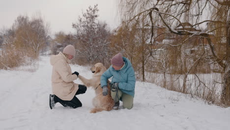 women and a dog in winter park