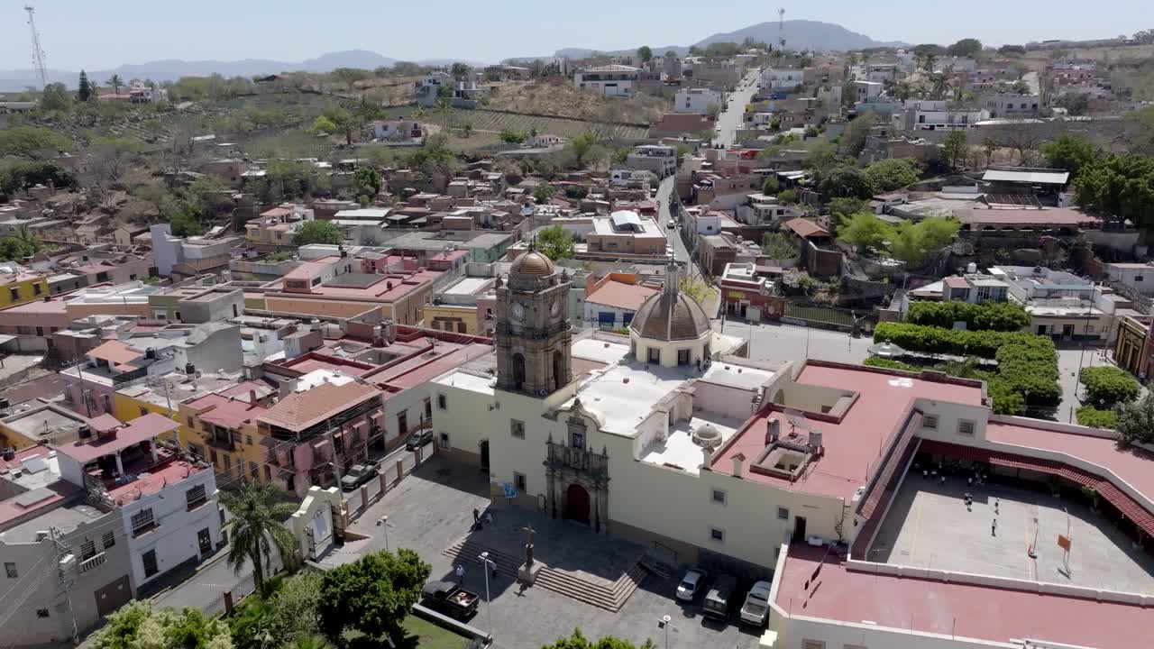 Parish of the Immaculate Conception catholic church in Amatitan in Mexican state of Jalisco, Blue agave farm fields in background, Drone shot