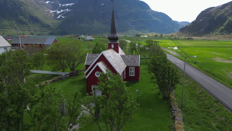 Orbital-aerial-view-over-the-beautiful-Flakstad-church-on-the-Lofoten-islands-on-a-spring-day