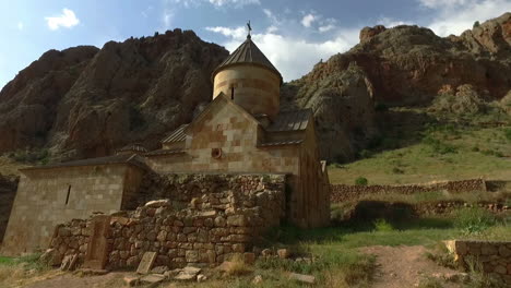 tracking shot over armenian monastery noravank built near the amaghu river. filmed during golden hour.