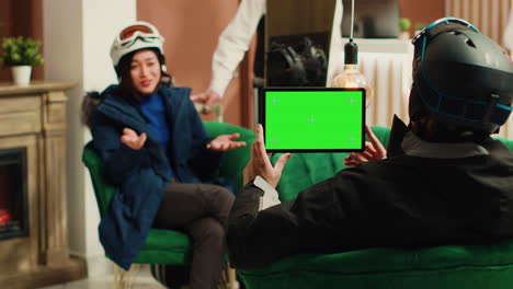 young man uses tablet with greenscreen