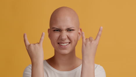bald woman with rock sign
