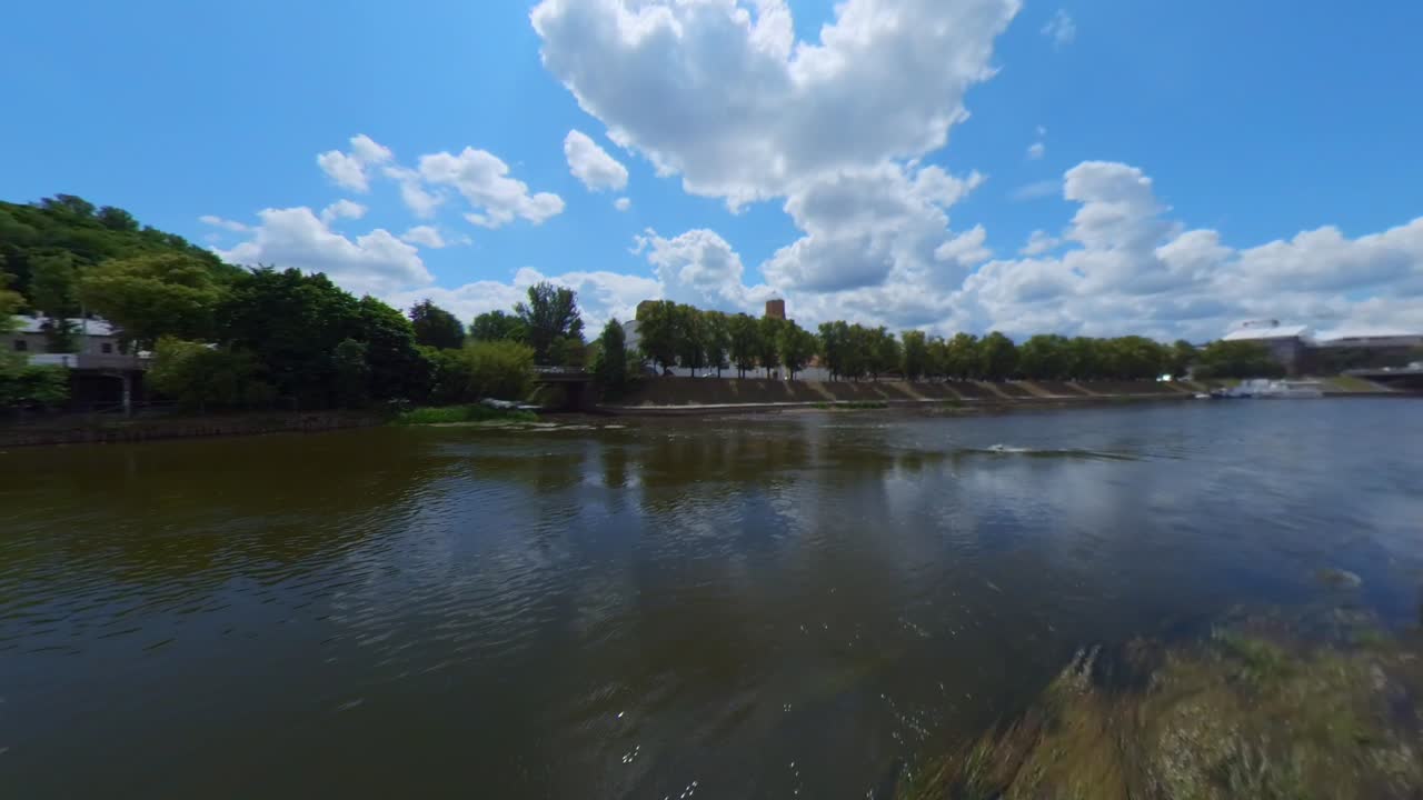 River landscape with trees and buildings