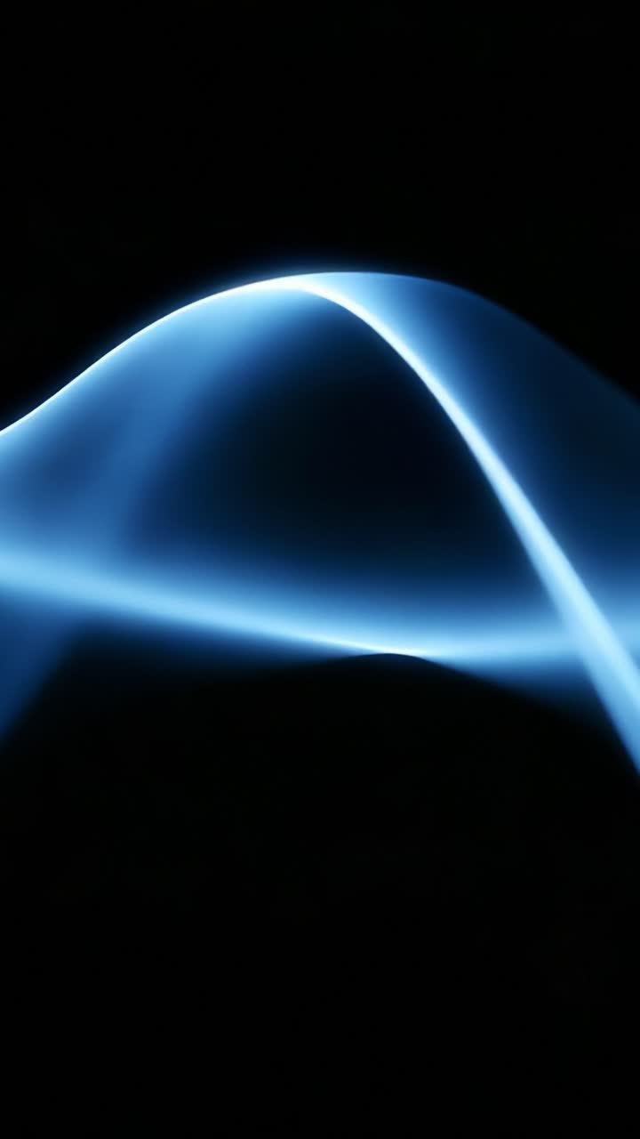 A captivating display of fluid motion in blue light, showcasing elegant curves and mesmerizing lines that twist and turn against a dark backdrop, evoking a sense of tranquility and beauty in simplicity