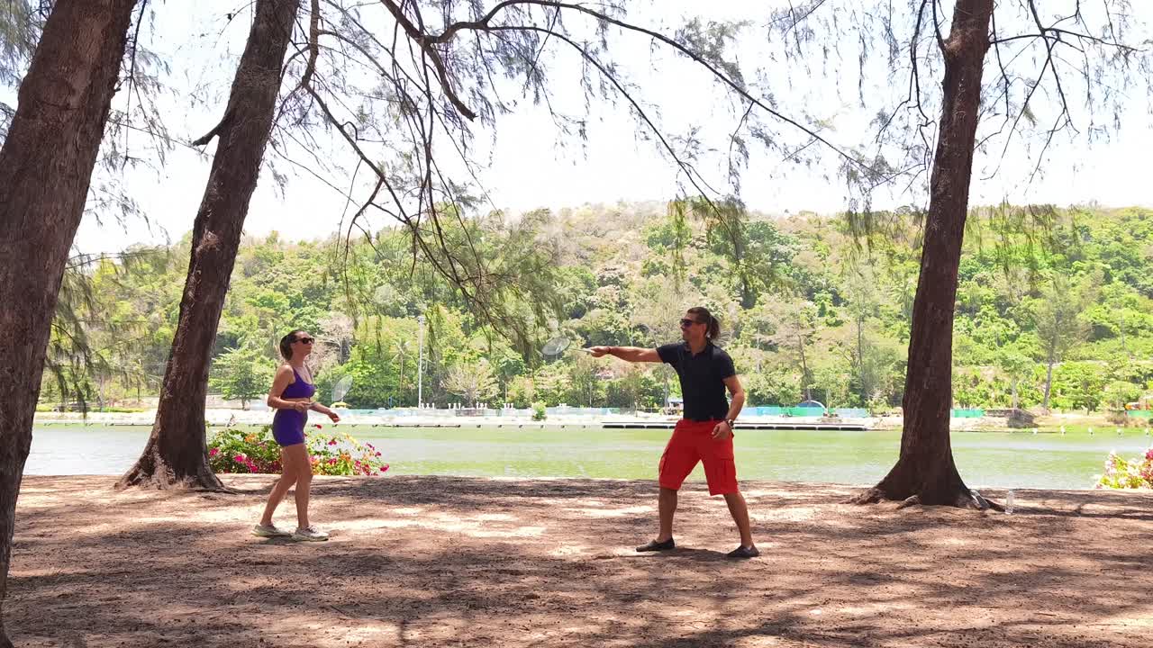 Couple Playing Badminton by the Lake