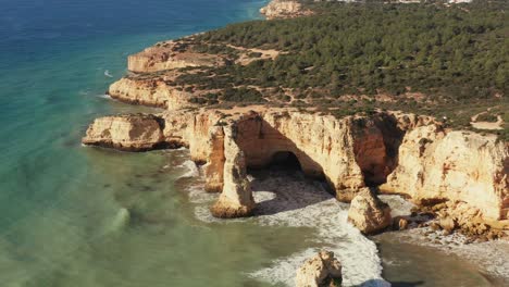 aerial tracking and tilting shot of beautiful limestone cliffs seen on the seven hanging valleys trail in the algarve region of portugal