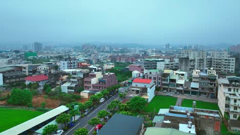 ascend drone shot of old buildings in miaoli city during foggy morning, taiwan