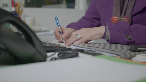 Lady-At-Work-Office-Writing-Down-Her-Appointments-And-Notes