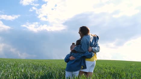 a very happy family hugs in the middle of a wheat field a very happy family hugs in the middle of a wheat field happy together denim family look