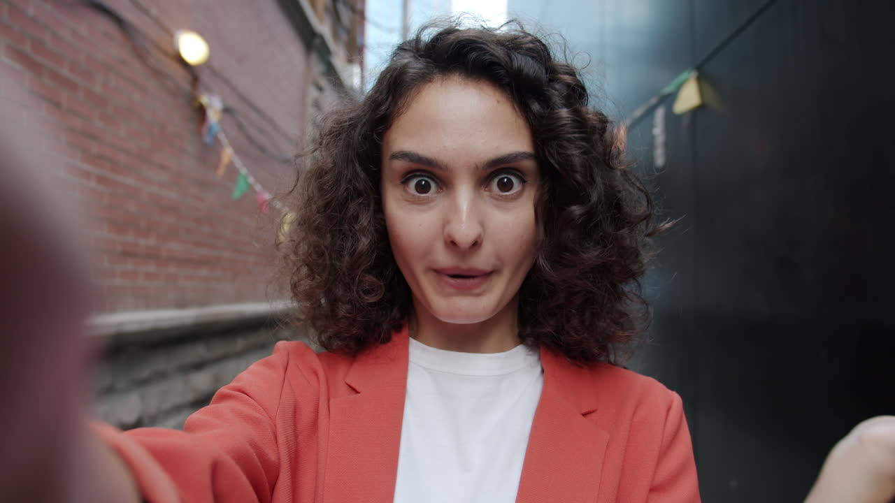 Woman Taking a Selfie in a City Alley