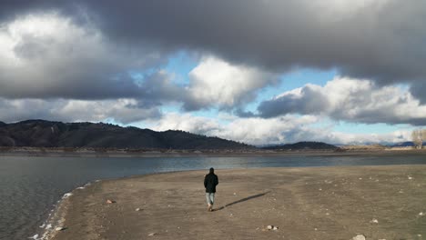 man walking along river bank in tehachapi california