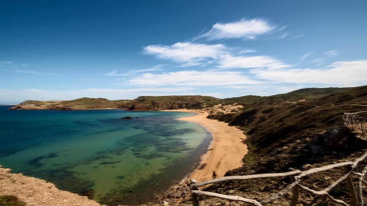 Cavalleria beach Menorca time lapse panning across idyllic crystal clear Mediterranean seascape