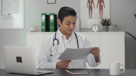 Happy-Indian-doctor-checking-medical-reports