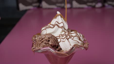 Pouring-caramel-in-slow-motion-over-an-ice-cream-dessert