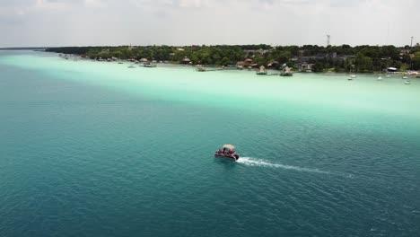 A-catamaran-with-people-sailing-in-Lake-Bacalar,-in-Qunatana-Roo,-Mexico