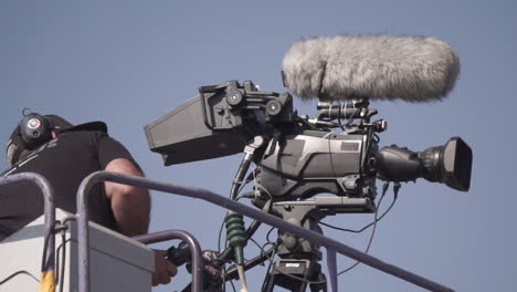 cameraman operating a camera on a crane