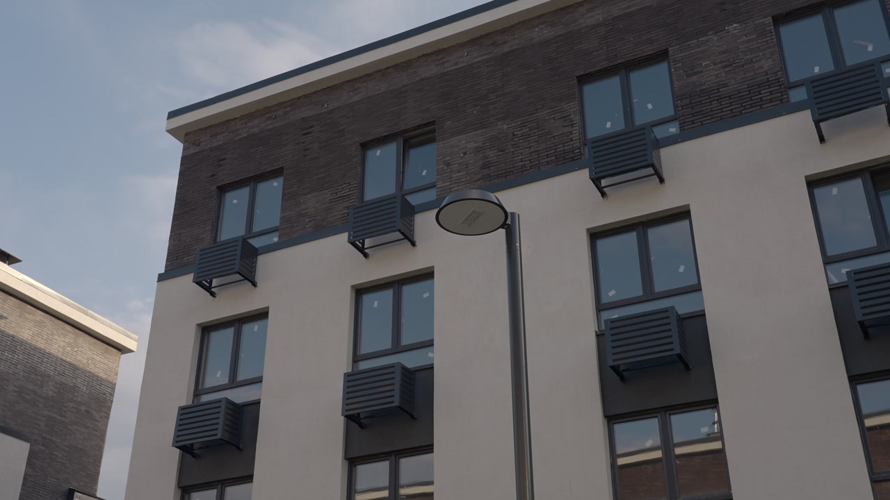 Single Streetlight Against Residential Facade, Metal Vents And Windows Create Industrial Rhythm, Neutral Tones