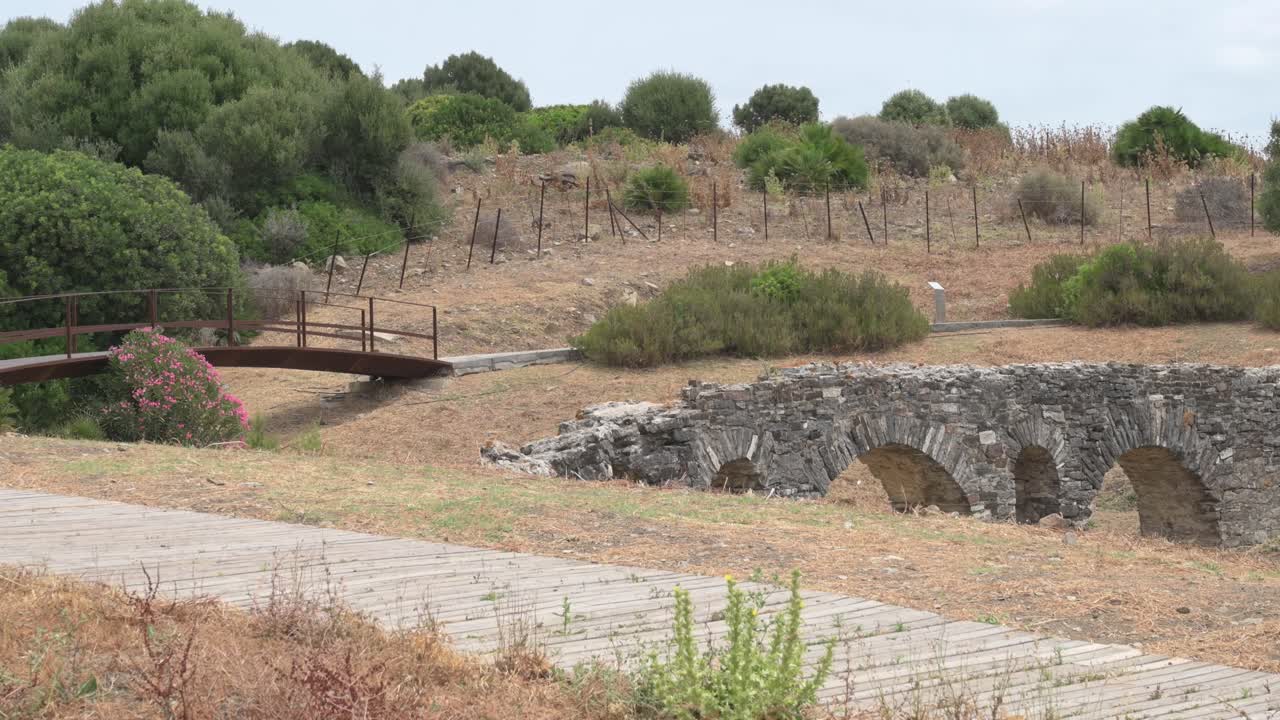 Ancient Roman bridge ruins in Baelo Claudia, Cadiz, showing deterioration and historical significance
