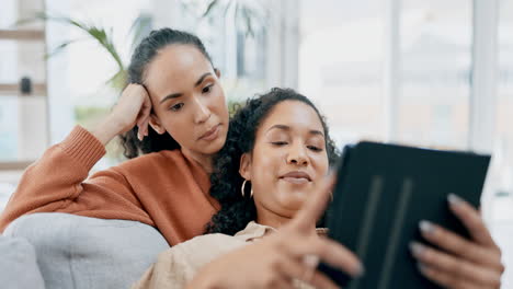 Lesbian-couple,-tablet-and-home-sofa-together-to