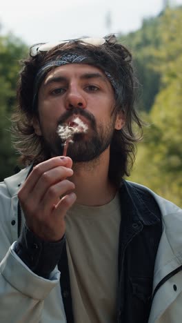 happy man blowing dandelion