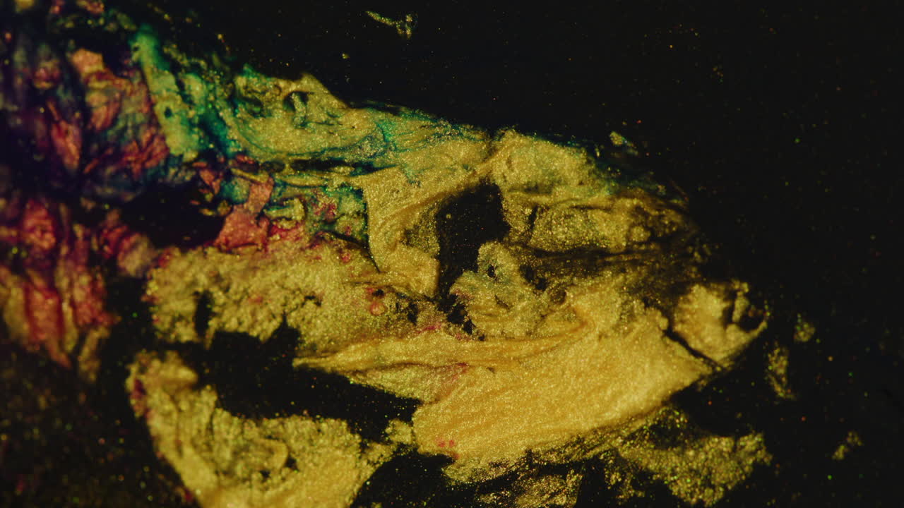 Flow of gold color particles on color mix abstract liquid