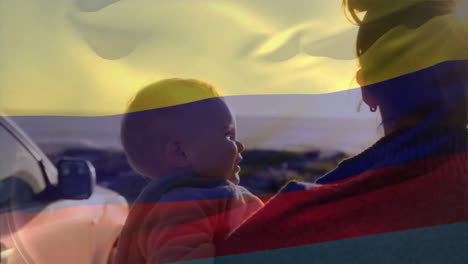 animation of colombian flag over caucasian mother, father and child on sunny beach