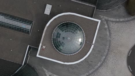 a top down view directly above an office complex on long island, new york with green glass skylights