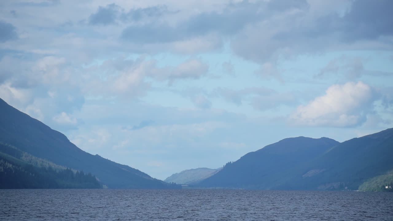 The beautiful blue, misty scenery of the Caledonian Canal in Scotland - wide shot