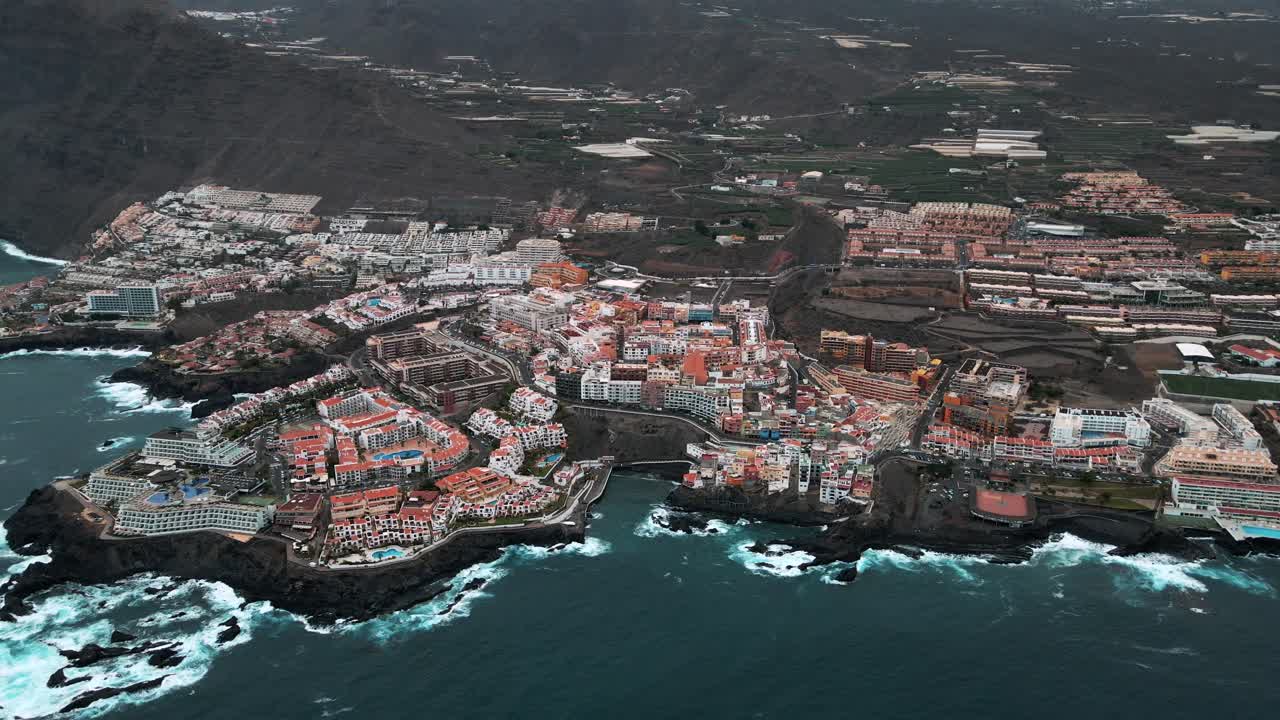Aerial Establishing Panning Shot Across Tenerife Spain Coastal Village Right By Blue Sea