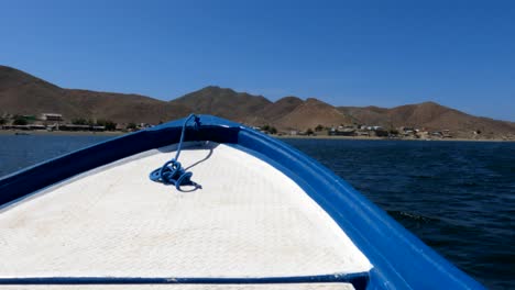 an open bow boat cruises through magdelena bay towards lands after a whale-watching tour