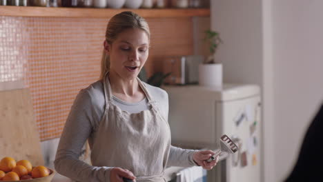 young-woman-making-homemade-pancakes-for-boyfriend-happy-couple-enjoying-breakfast-together-relaxing-at-home-on-weekend