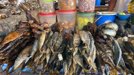 selling dried fish in a market near kumasi, ghana