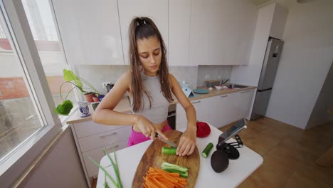 young woman preparing vegetables in a modern kitchen
