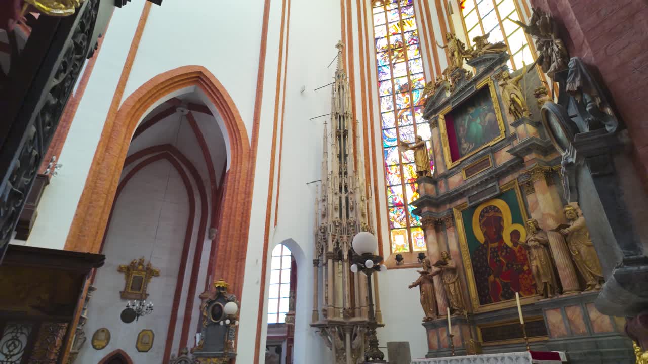 Beautiful interior of St Elizabeth Church featuring grand architecture, stained glass windows, and intricate religious artwork in Wroclaw, Poland.