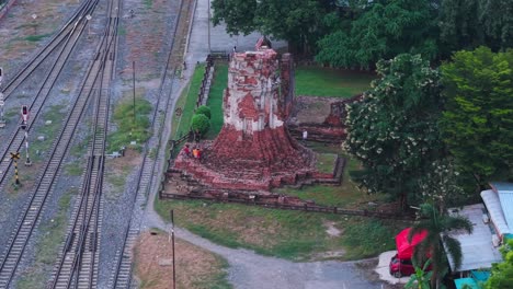 ruined temple near train tracks in thailand
