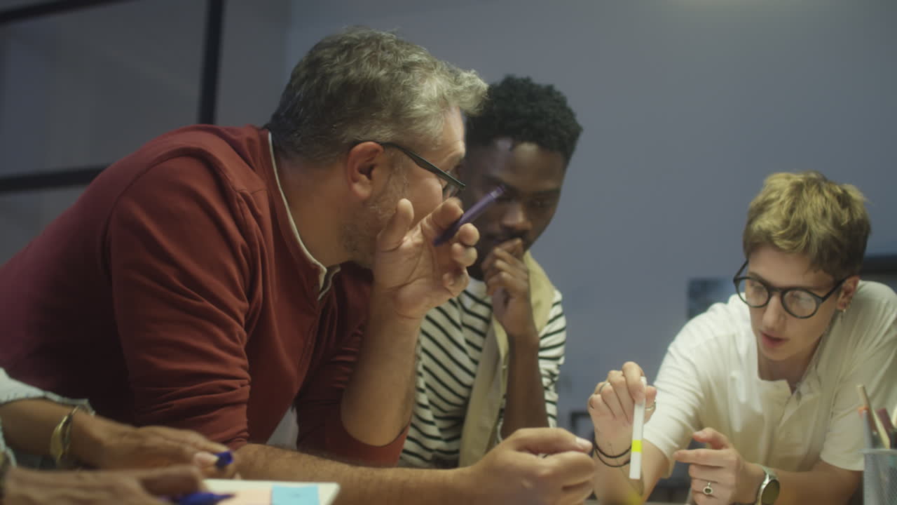 Group of Coworkers Discussing Project at Night