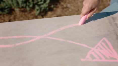 woman hand using pink chalk writing happiness on ground teenage girl enjoying creativity