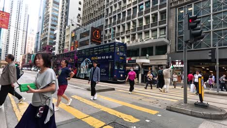 pedestrians crossing a bustling city intersection