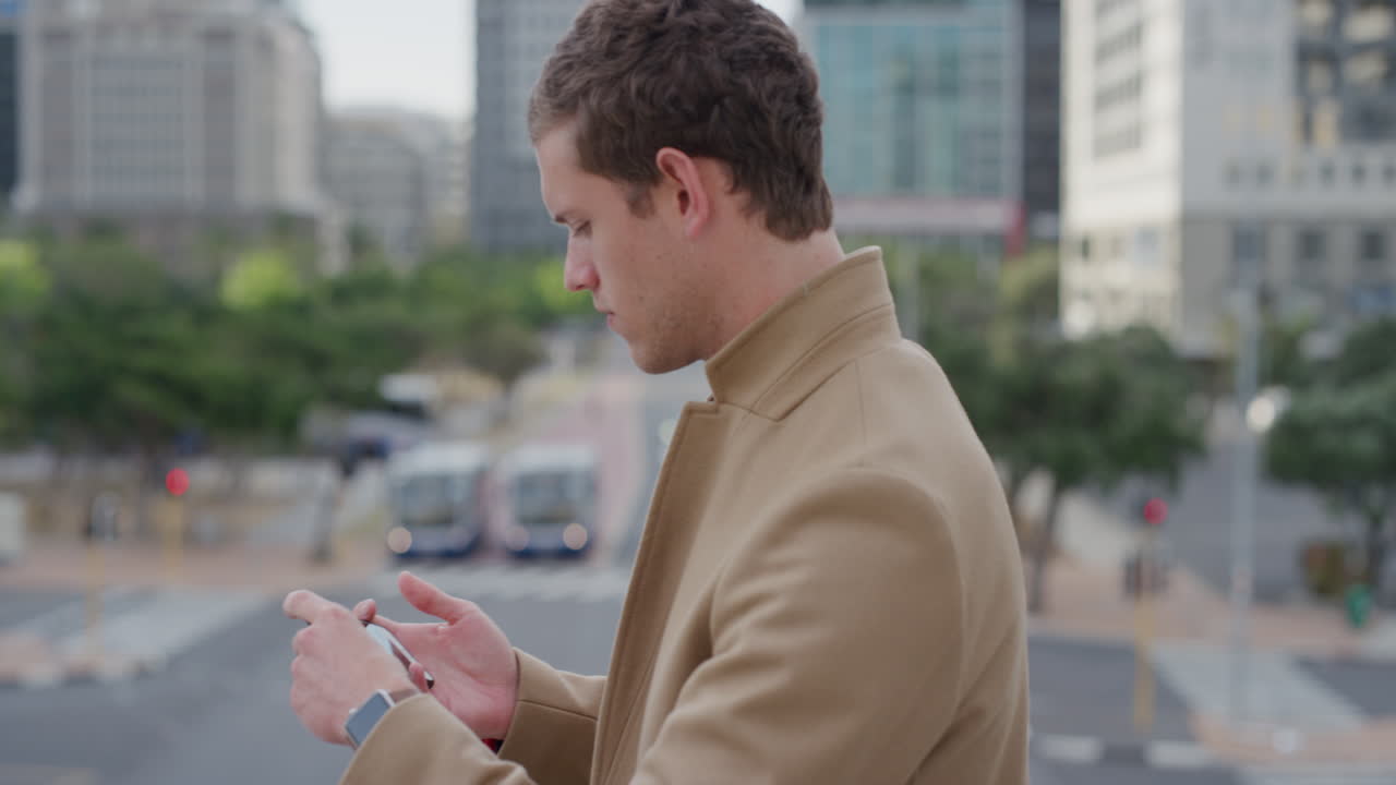 portrait young handsome businessman using smartphone taking photos in city on mobile phone camera enjoying urban sightseeing caucasian male commuter slow motion