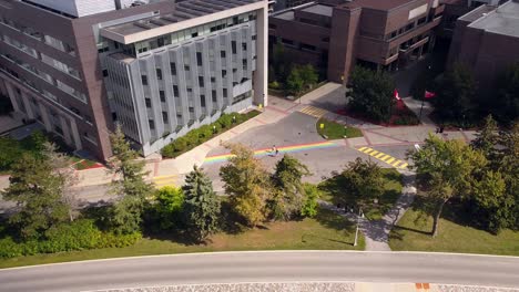 canadian students walk across pride rainbow crosswalk on ontario university (carleton) campus
