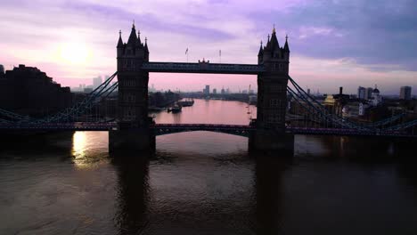 incredible 4k footage of a drone passing through tower bridge in thames river at sunset, london