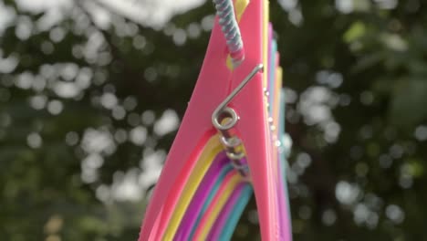 clothes pegs hanging on a washing line on a windy day