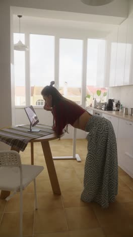 woman having a video call in her kitchen