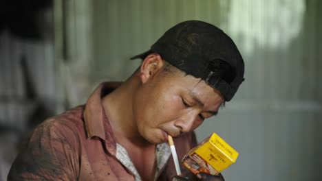 man smoking in a rural setting