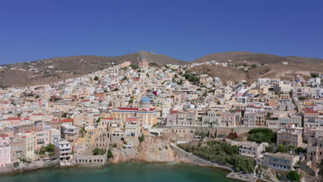 aerial: slow panning drone shot of ermoupoli in syros island, greece on a sunny day