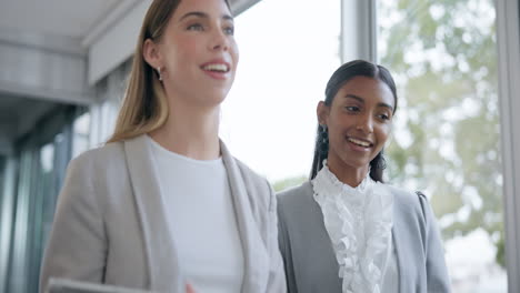 business women, walking and talking in an office